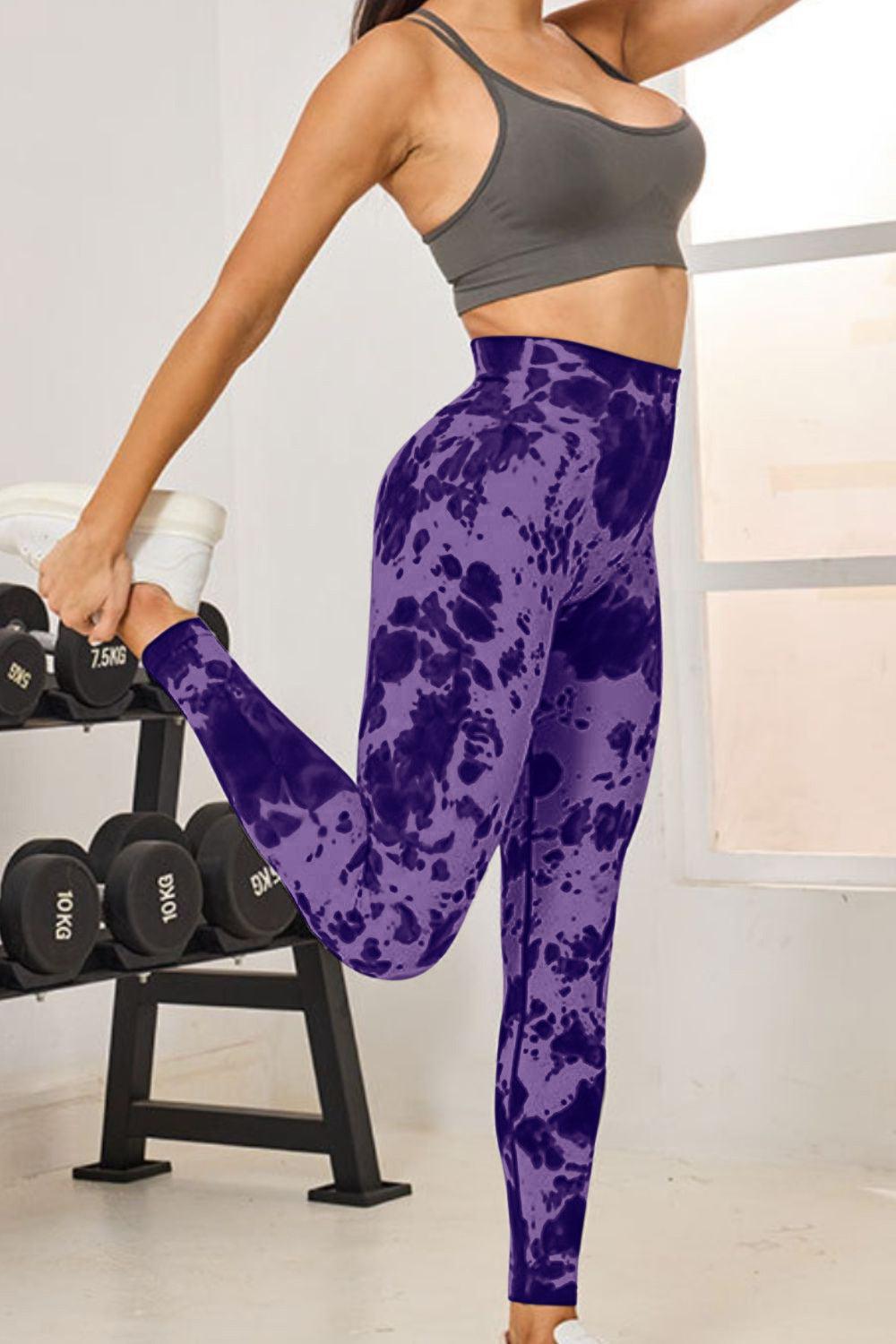 a woman in a sports bra top and purple leggings