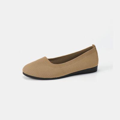 a woman's tan shoe with a black heel