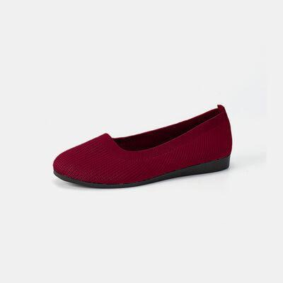 a pair of red shoes on a white background