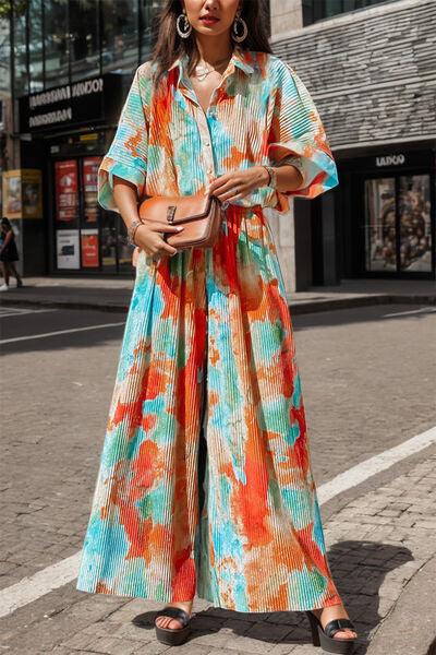 a woman in a colorful dress is standing on the street
