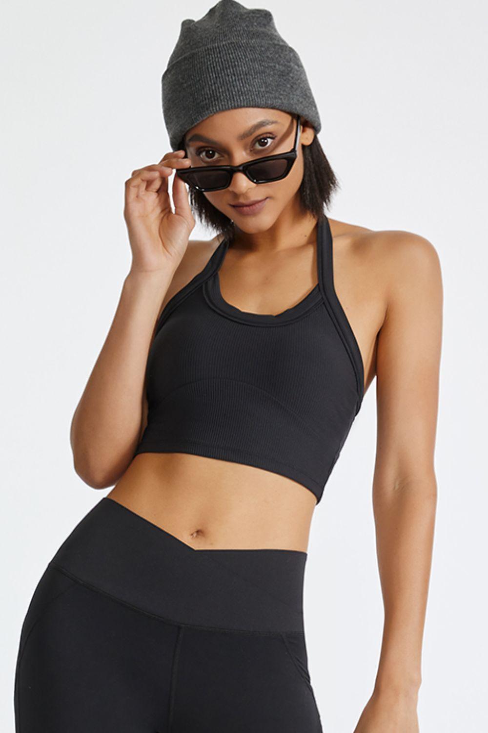 a woman wearing a black sports bra top and black leggings