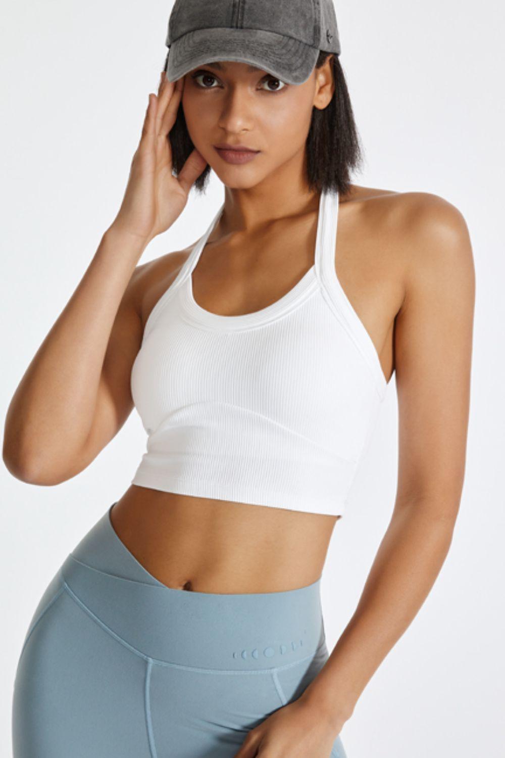 a woman in a white top and blue leggings