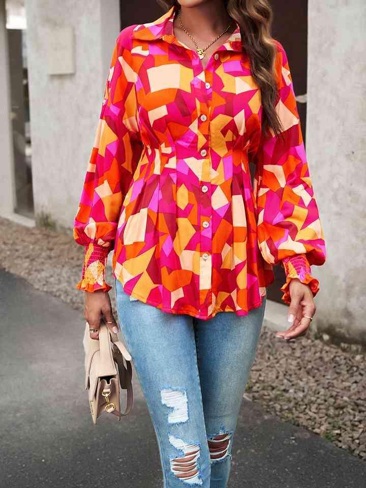 a woman in a colorful shirt and ripped jeans