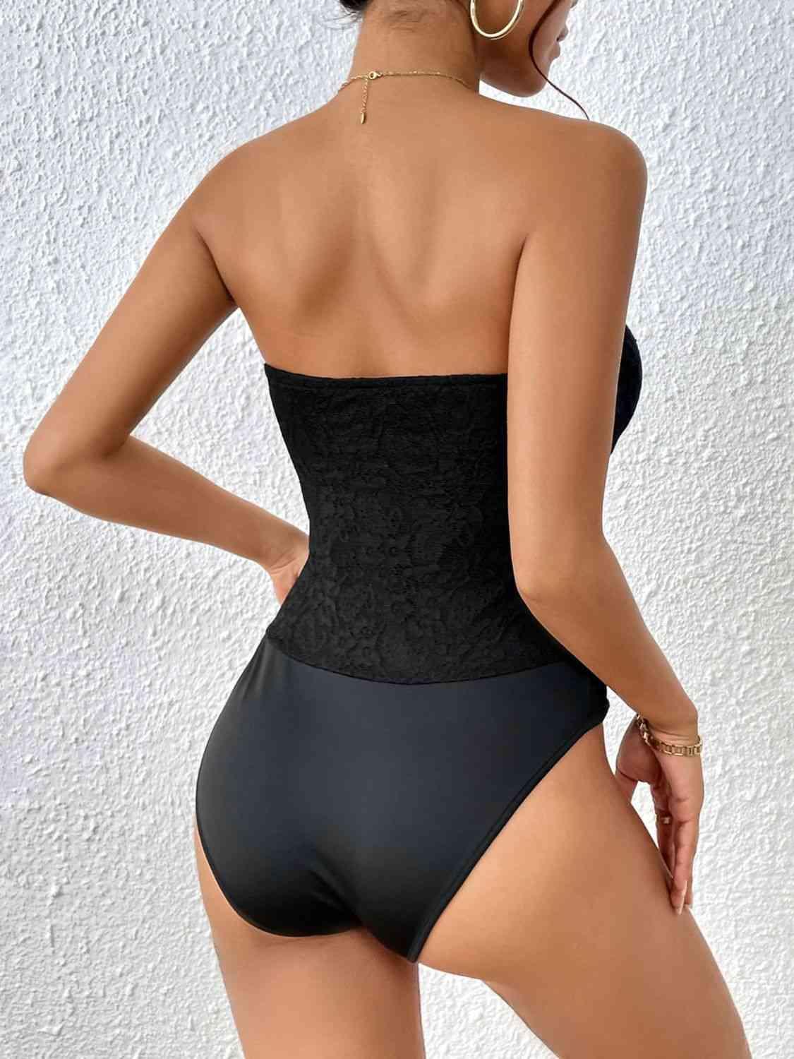 a woman in a black and grey bodysuit