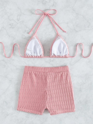 a pink and white bikini top and pink shorts