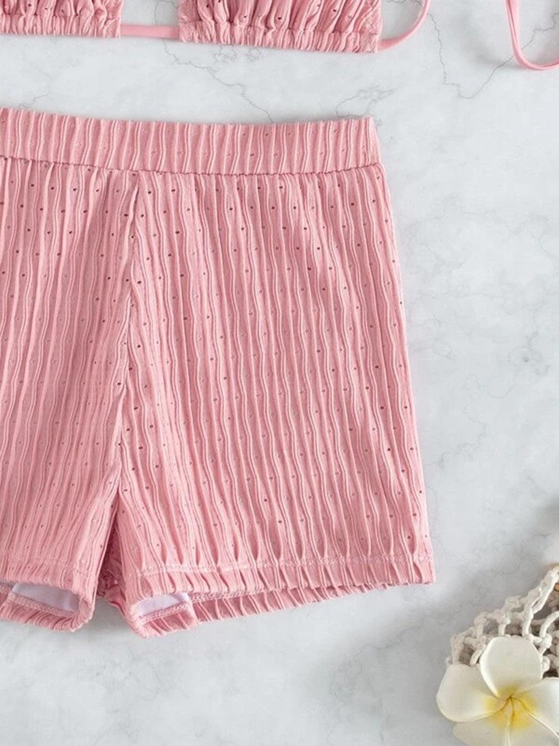a pair of pink shorts next to a white flower