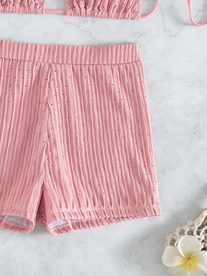 a pair of pink shorts next to a white flower