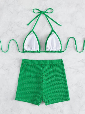 a green bikini top and green shorts