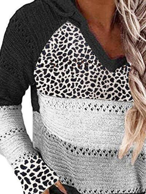 a woman wearing a sweater with a leopard print on it
