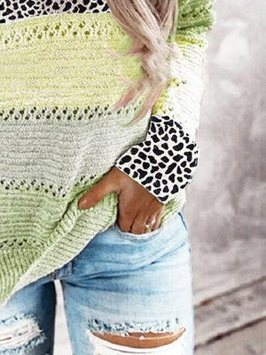 a woman wearing ripped jeans and a green sweater
