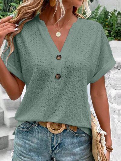 a woman wearing a green blouse and jeans