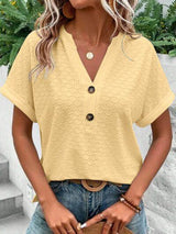 a woman wearing a yellow top and jeans