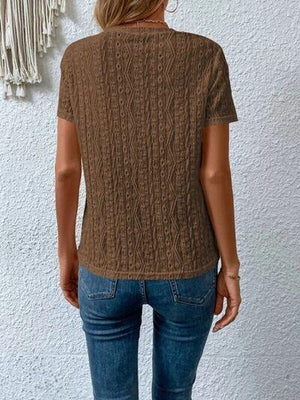 a woman wearing a brown sweater and jeans