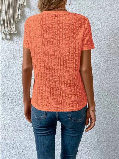 a woman wearing an orange sweater and jeans