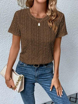 a woman wearing a brown shirt and jeans
