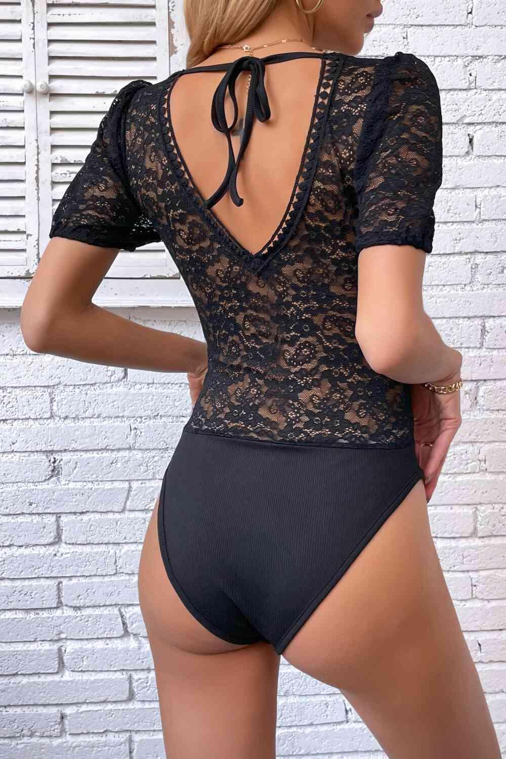 the back of a woman wearing a black bodysuit
