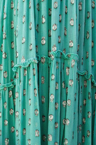 a close up of a green dress with flowers on it