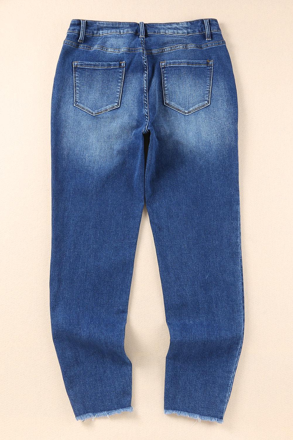 a pair of blue jeans sitting on top of a white wall