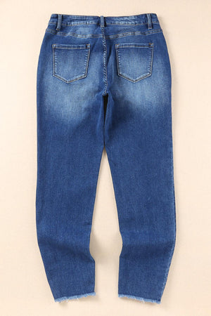 a pair of blue jeans sitting on top of a white wall