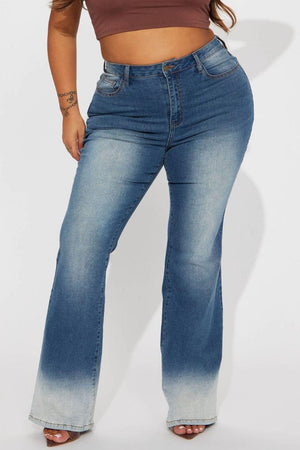 a woman in a brown top and blue jeans