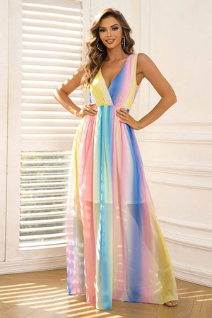 a woman in a rainbow colored dress posing for a picture