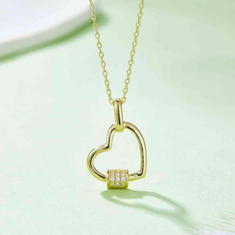 a heart shaped pendant with two diamonds on a chain