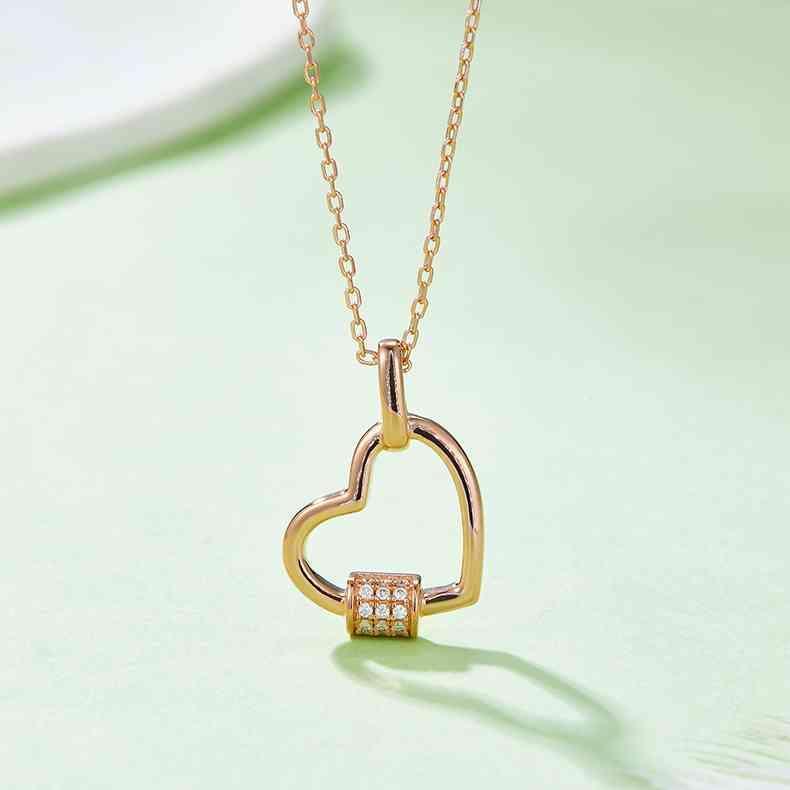 a diamond heart pendant on a gold chain