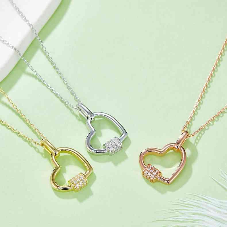 three necklaces on a green surface
