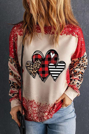 a woman wearing a sweater with hearts on it