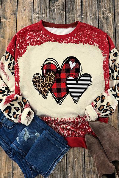 a red and white sweater with hearts on it