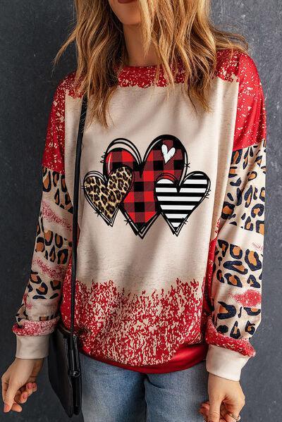 a woman wearing a red and white sweater with hearts on it