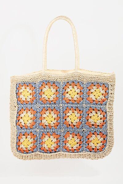 a crocheted bag with flowers on it