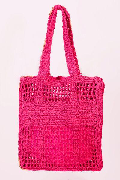 a pink crocheted bag hanging from a hook