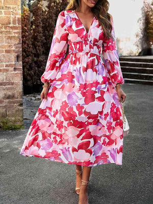 a woman in a pink floral print dress