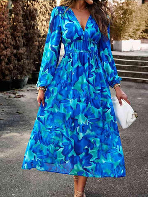 a woman in a blue floral print dress