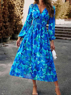 a woman wearing a blue floral print dress