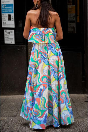 a woman in a colorful dress is walking down the street