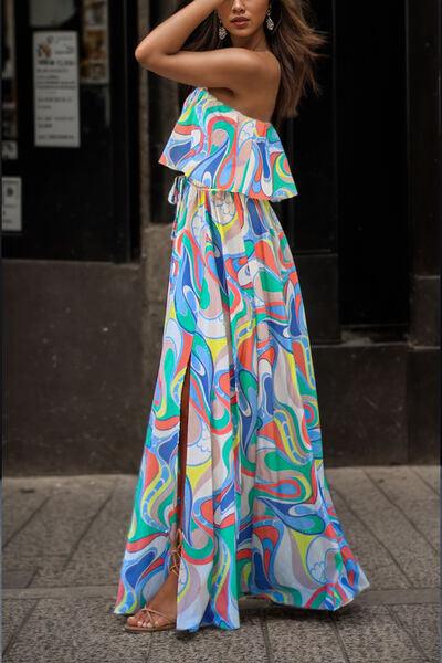 a woman in a colorful dress standing on a sidewalk