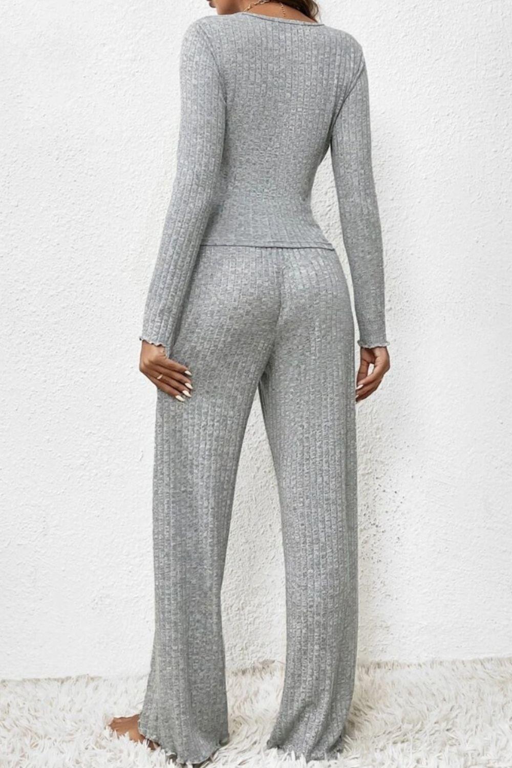 a woman wearing a grey knit jumpsuit and heels