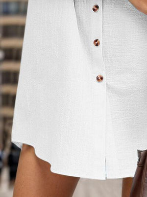 a woman in a white dress holding a brown purse