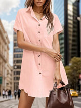 a woman in a pink shirt dress holding a brown purse