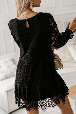 a woman wearing a black lace dress