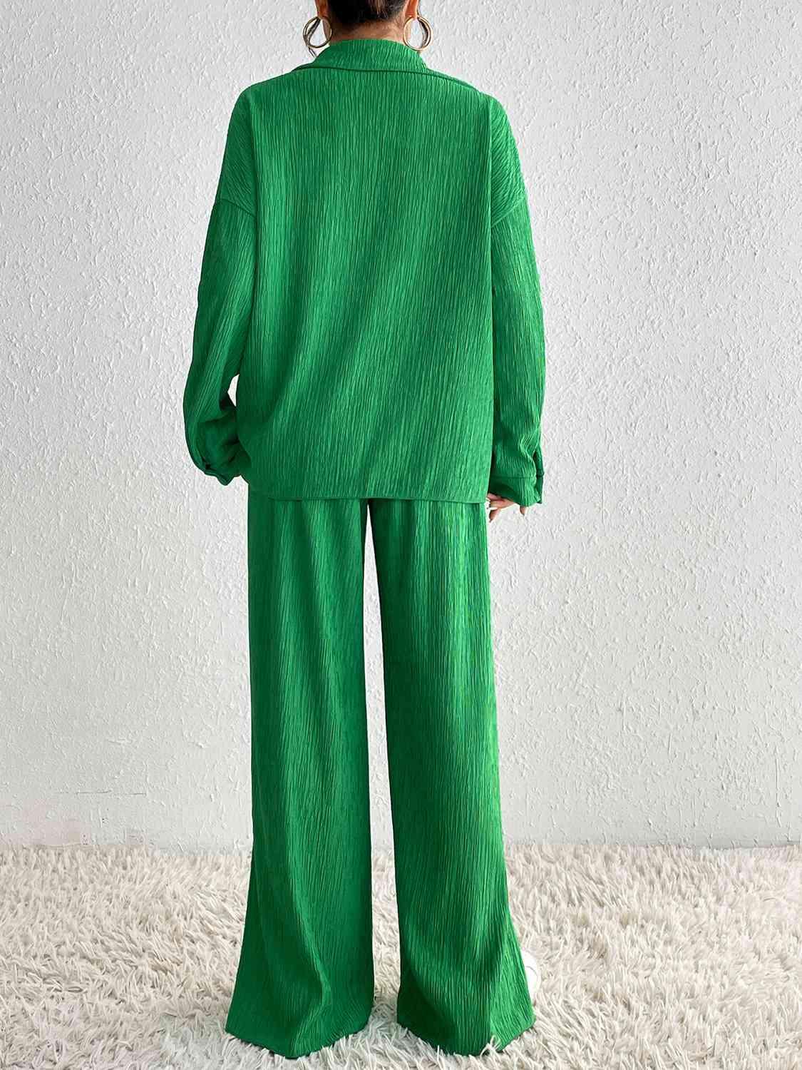 a woman in a green suit standing on a white rug