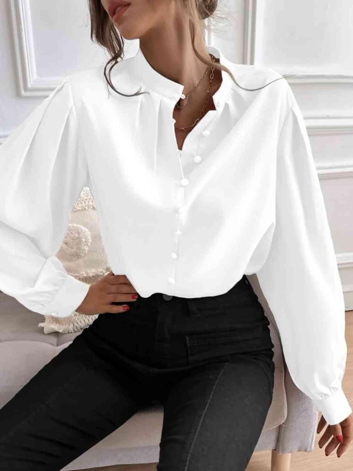 a woman wearing a white shirt and black pants