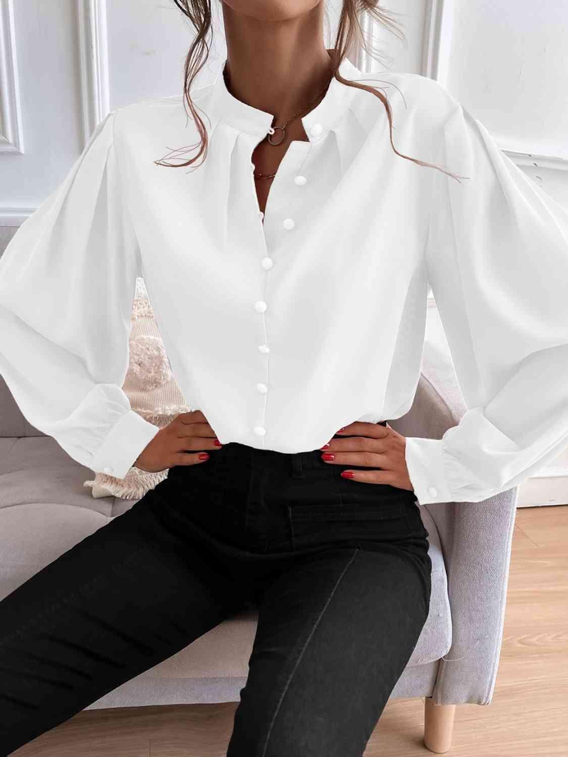 a woman sitting on a couch wearing a white shirt