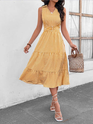 a woman in a yellow dress and straw hat