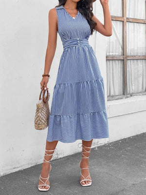 a woman wearing a blue and white striped dress