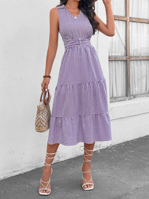 a woman wearing a purple and white striped dress