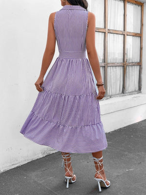 a woman wearing a purple and white striped dress