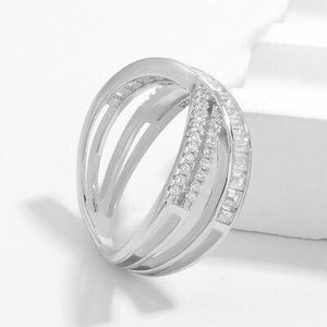 a diamond ring sitting on top of a white surface